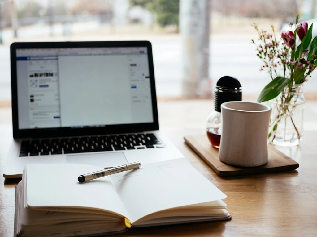 A laptop and the open notebook