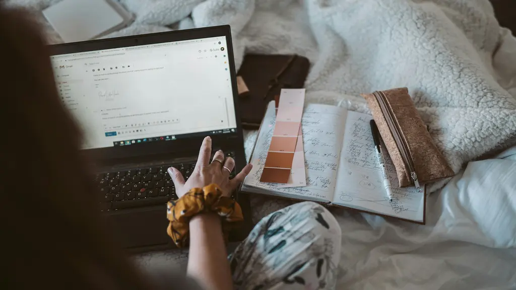 A woman creating an email on her laptop