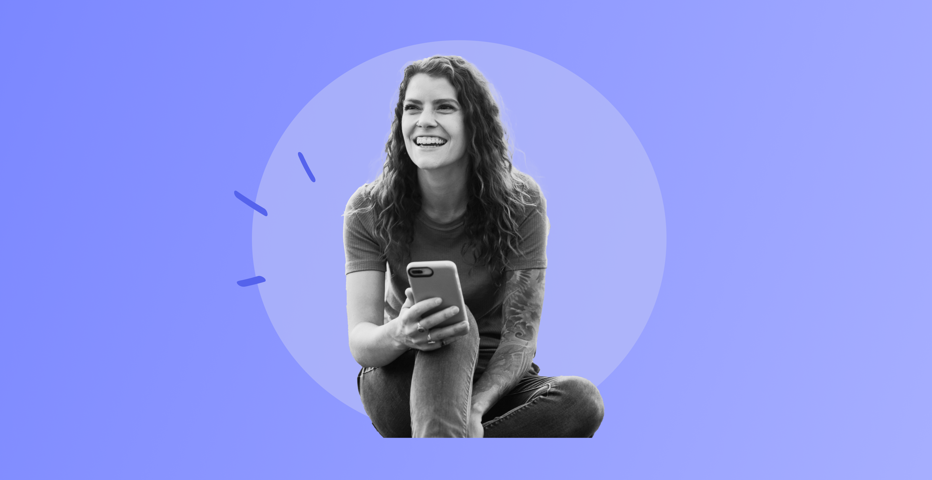 Woman smiling holding a phone.