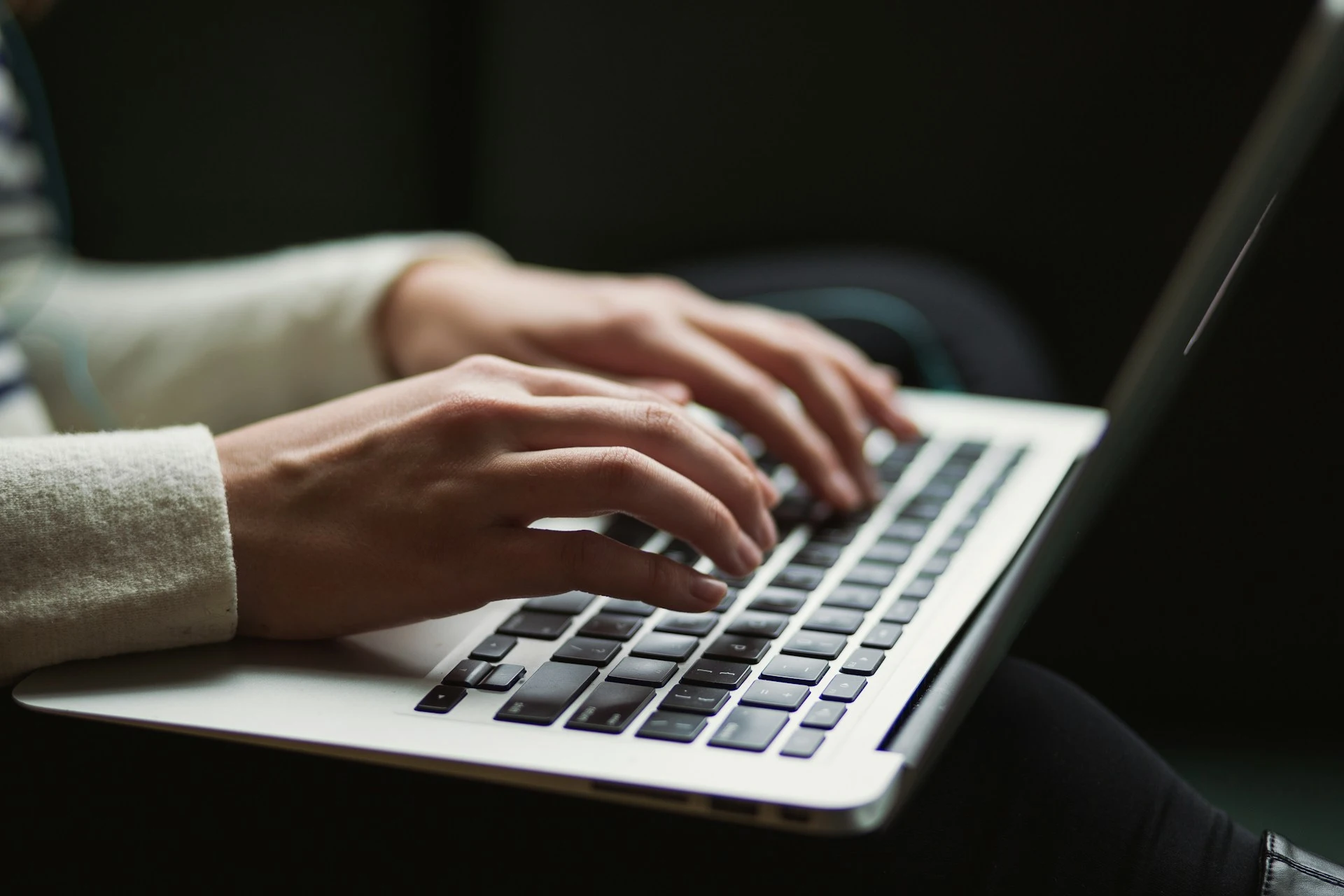 Person typing on laptop.