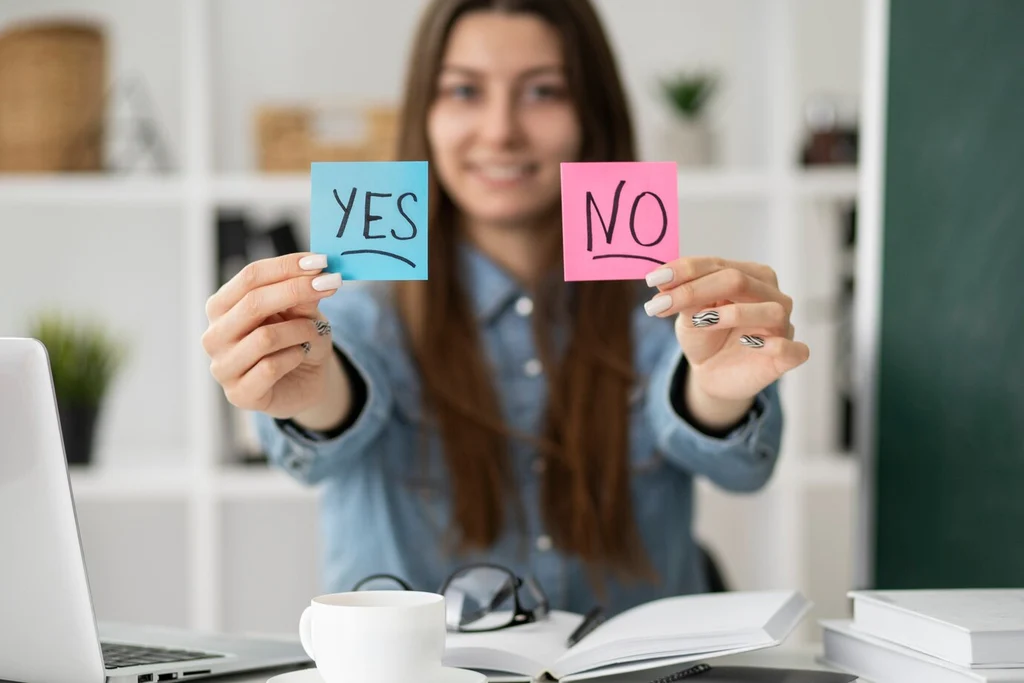 An image of a woman holding a YES and NO sticky notes