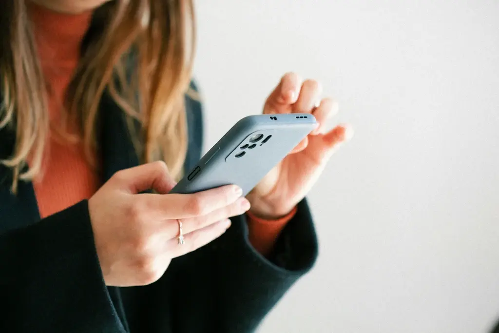 A woman typing on her phone